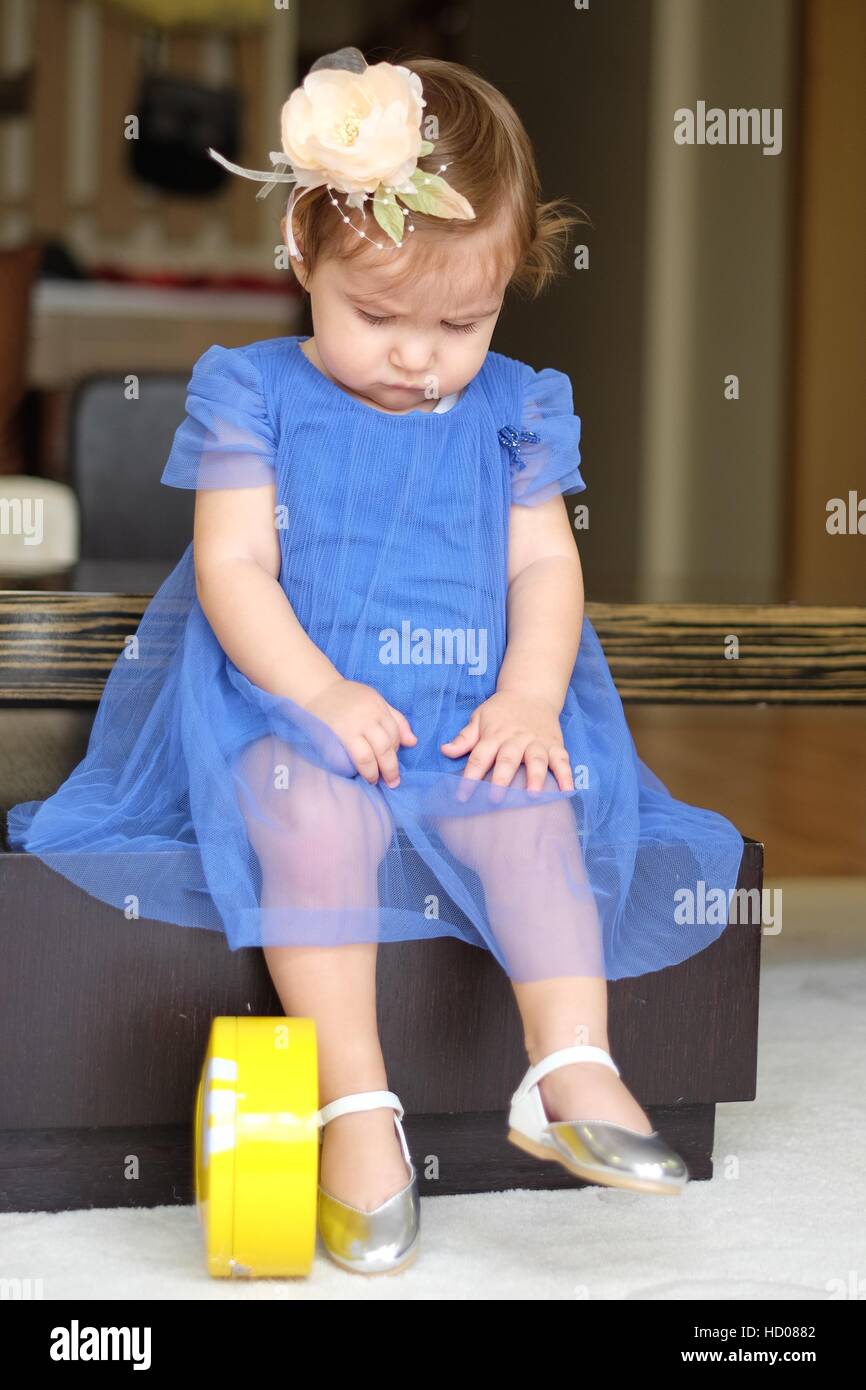 blue dress little girl sitting Stock Photo - Alamy