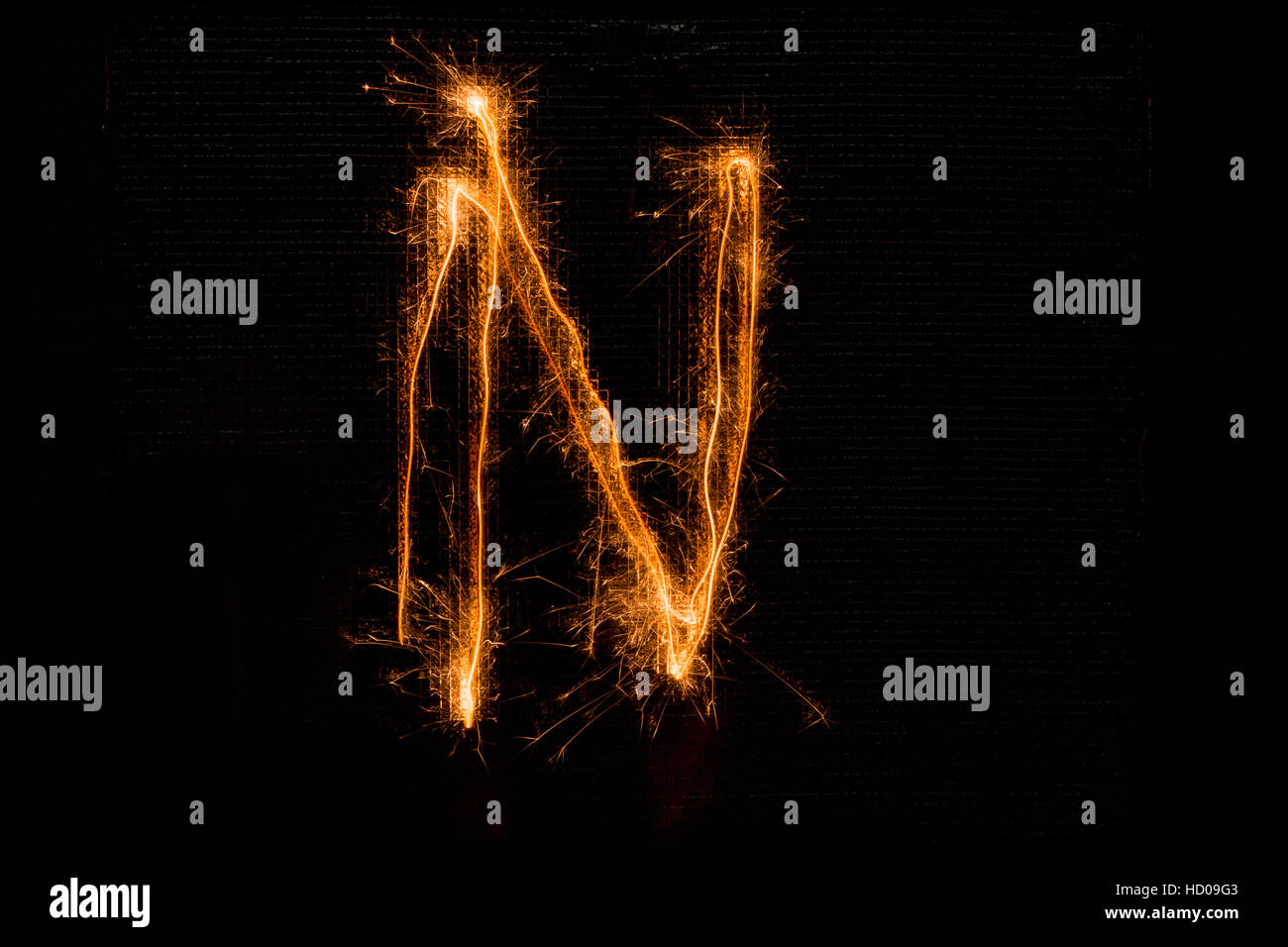 Letter N made of sparklers on black Stock Photo