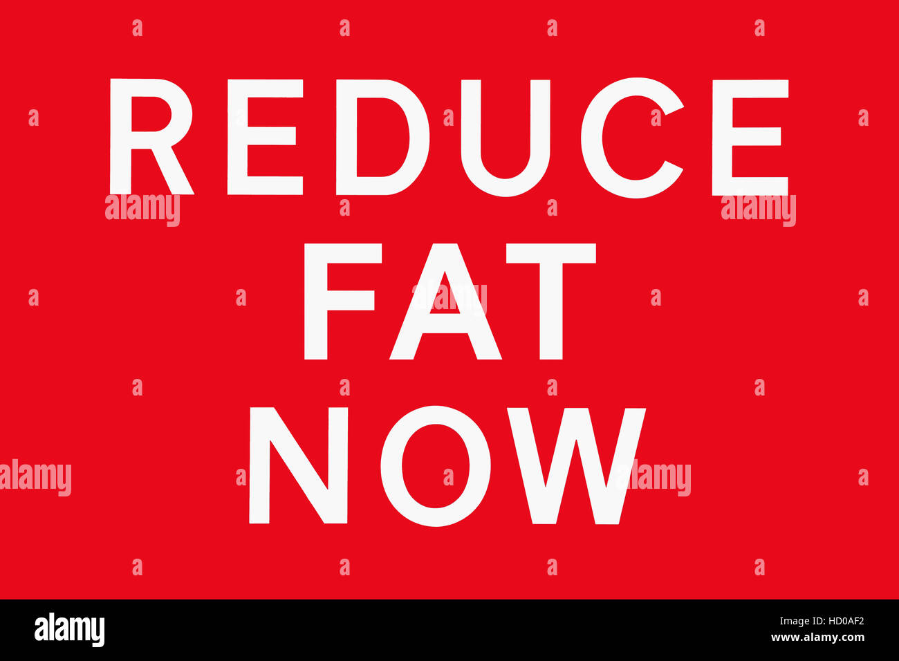 White text on red background REDUCE FAT NOW, symbol for health risk, spoof of road signs in the UK Stock Photo