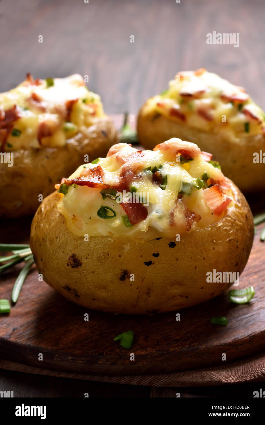 Stuffed potato with bacon, cheese and green onion Stock Photo
