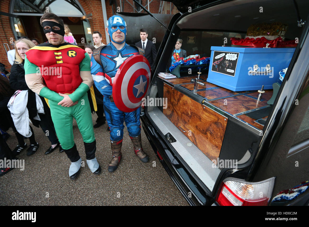 Pallbearers dressed as superheroes wait by the hearse containing the coffin of 18-year-old Arthur Peebles before his funeral at North East Surrey Crematorium in Morden, conducted by Co-op Funeralcare. Stock Photo