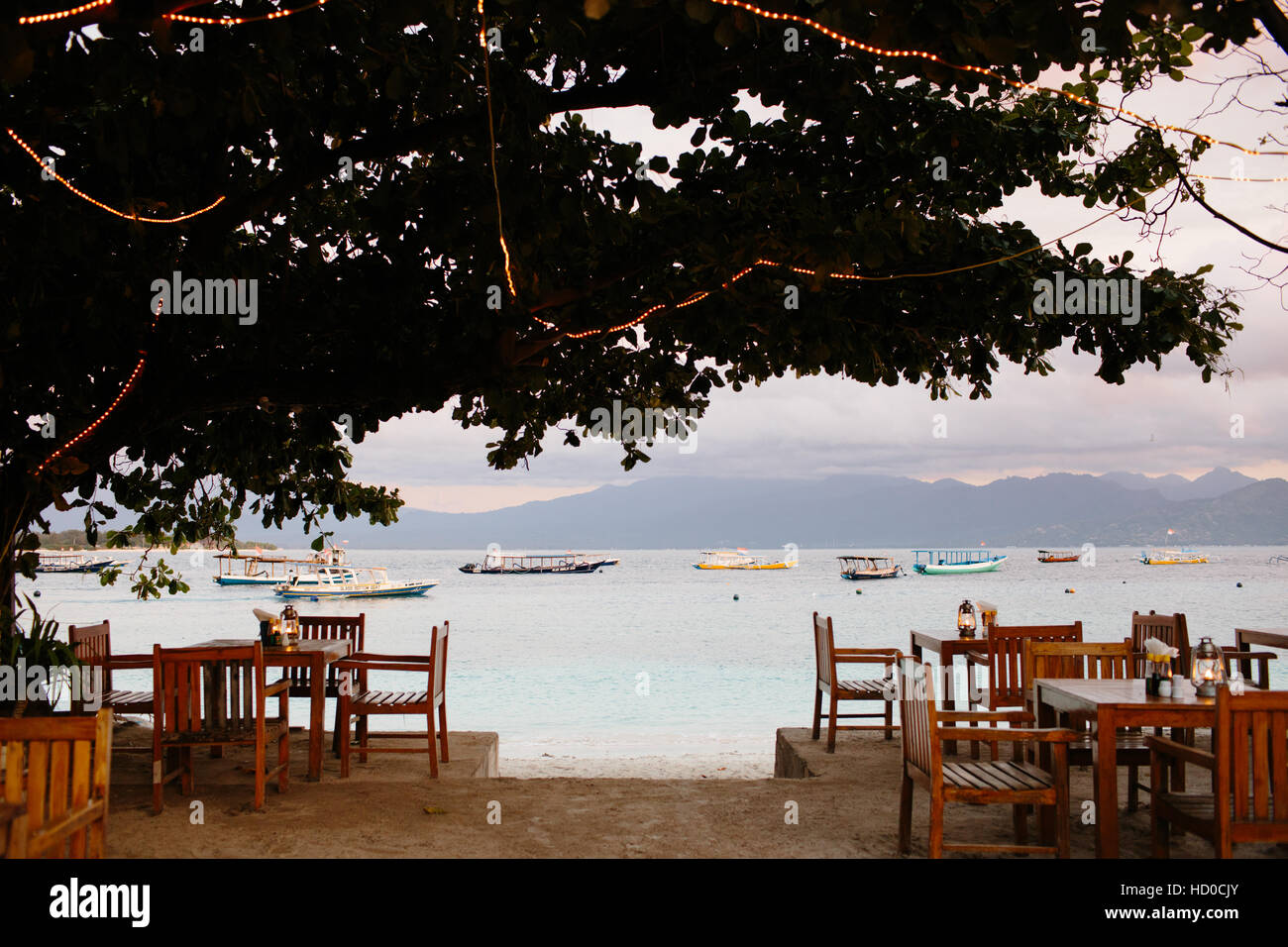 A view of the sea, boats and Lombok from a beachside restaurant on Gili Trawangan Stock Photo