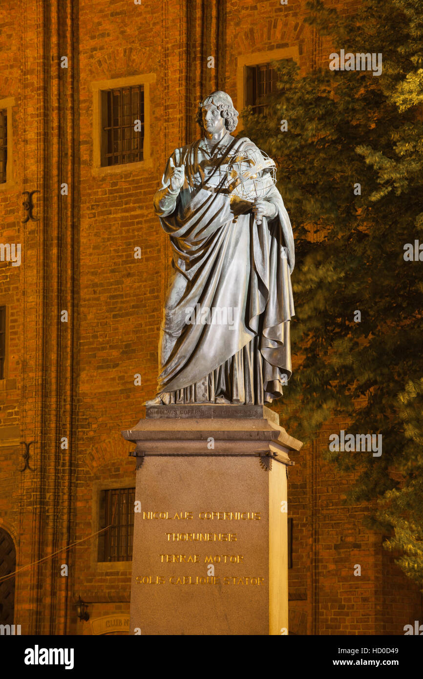 Astronomer Nicolaus Copernicus monument at night in city of Torun, Poland Stock Photo