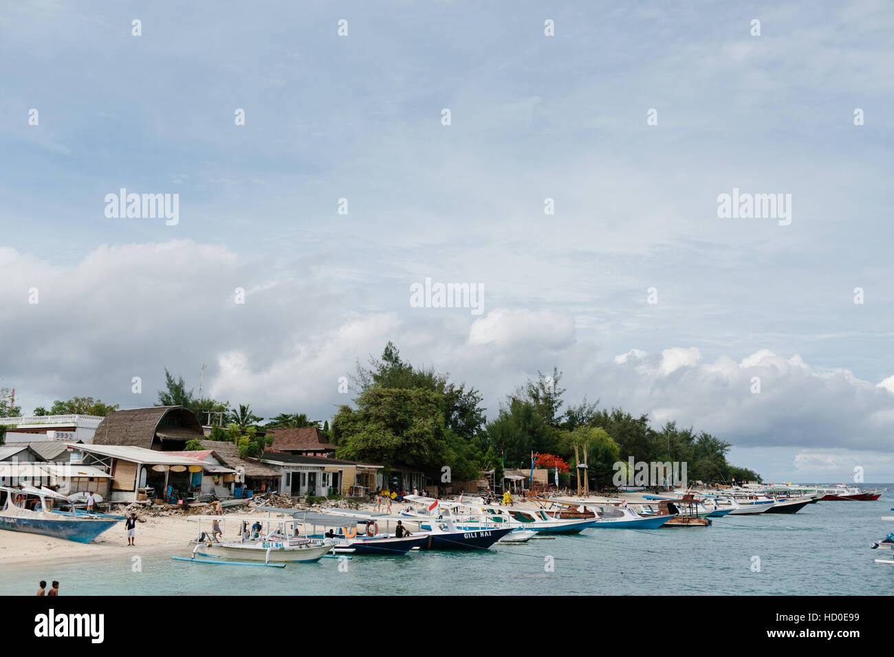 A view of the eastern beach of Gili Trawangan with many boats lining the shore Stock Photo
