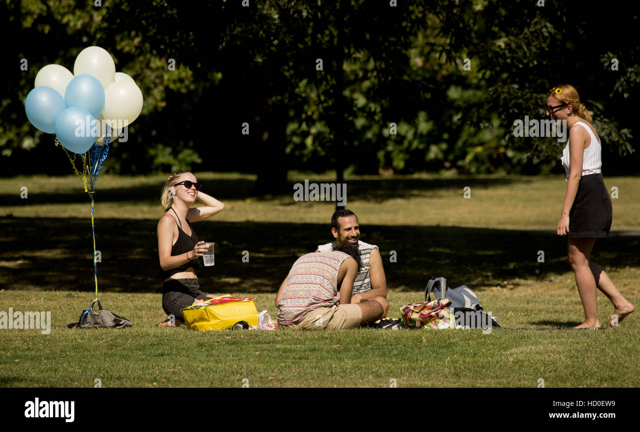 People enjoying the warm weather in regents park, London Featuring