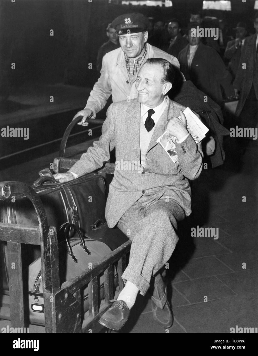 Director Carmine Gallone arriving in West Germany for the premiere of