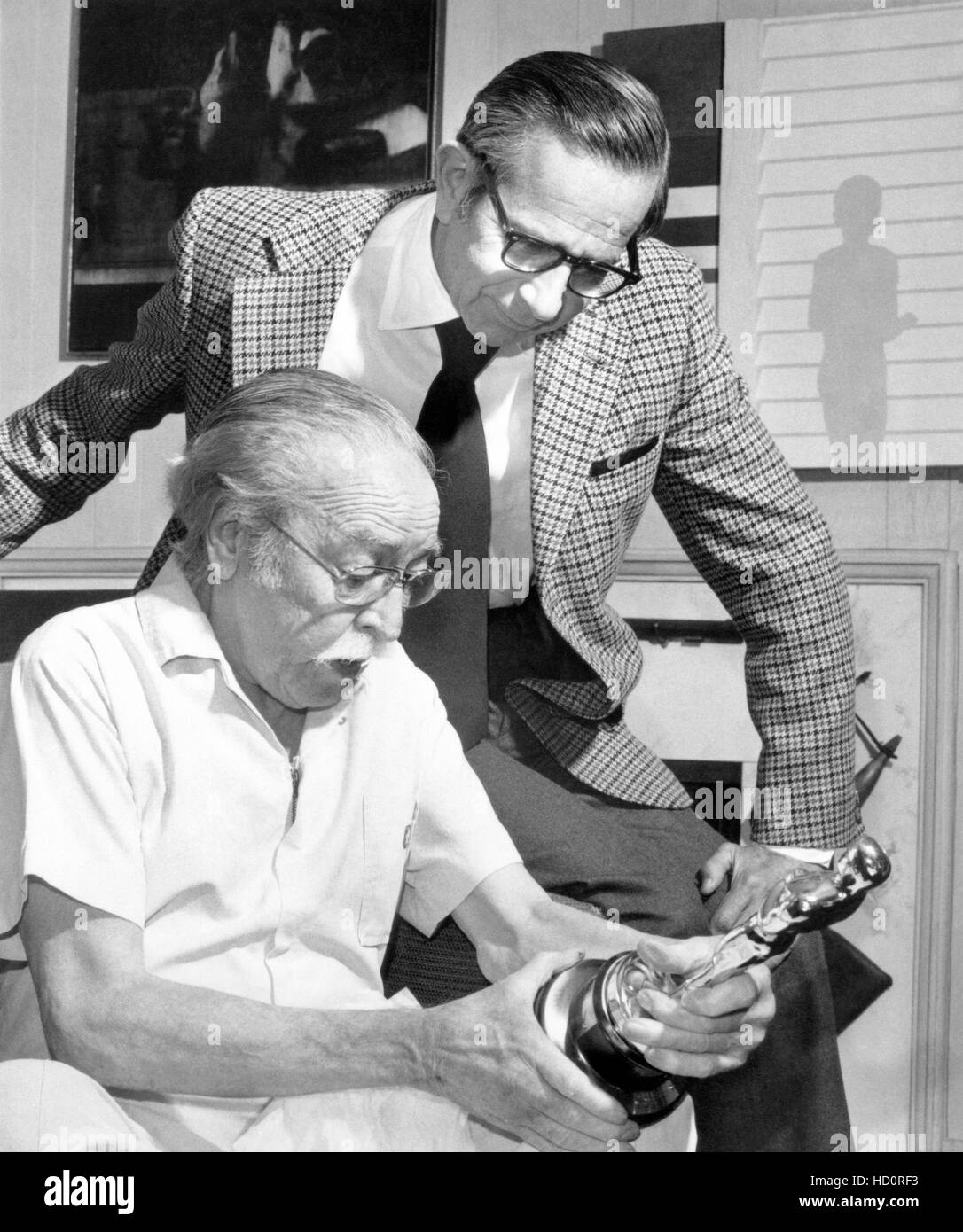 Dalton Trumbo (left) holding his Oscar Award for 'THE BRAVE ONE', ca ...