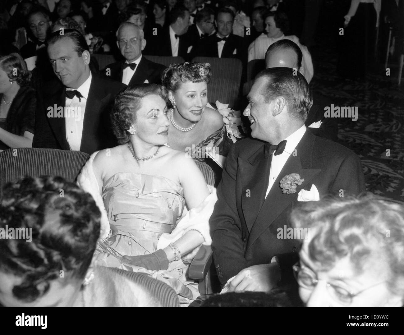 Irene Dunne, center, gossips with Douglas Fairbanks, Jr., and his ...