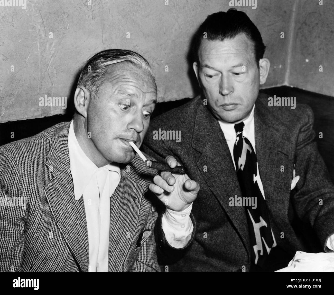 Jack Benny, Fred Allen, lighting up cigarette for confirmed cigar ...