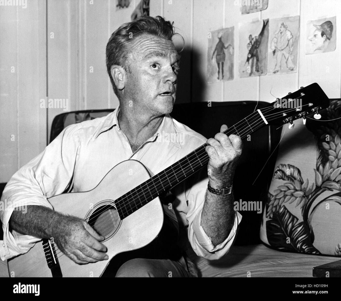 James Cagney playing guitar on set of "Mister Roberts", 1955 Stock