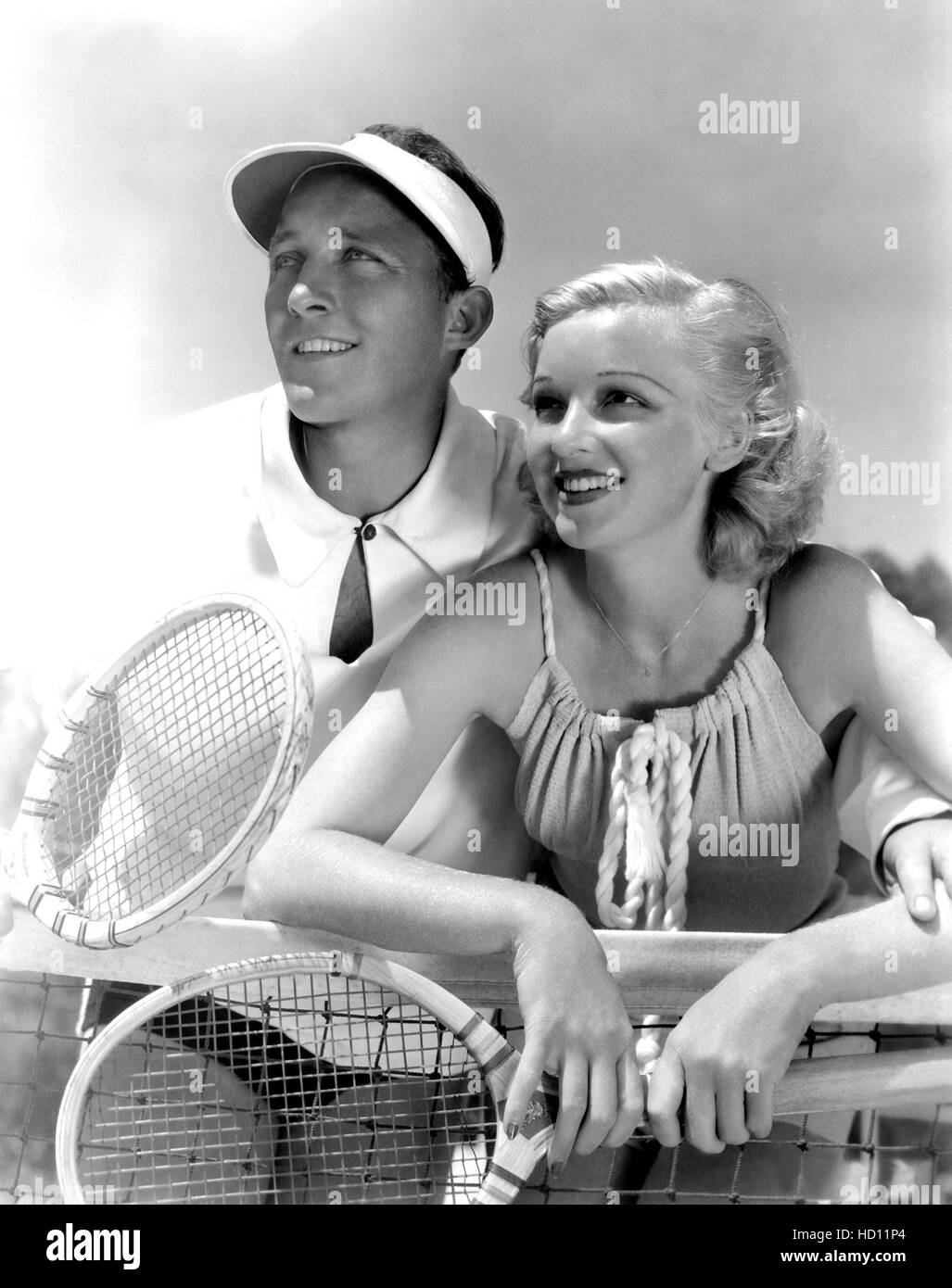 BING CROSBY with wife DIXIE LEE on their tennis court in full game