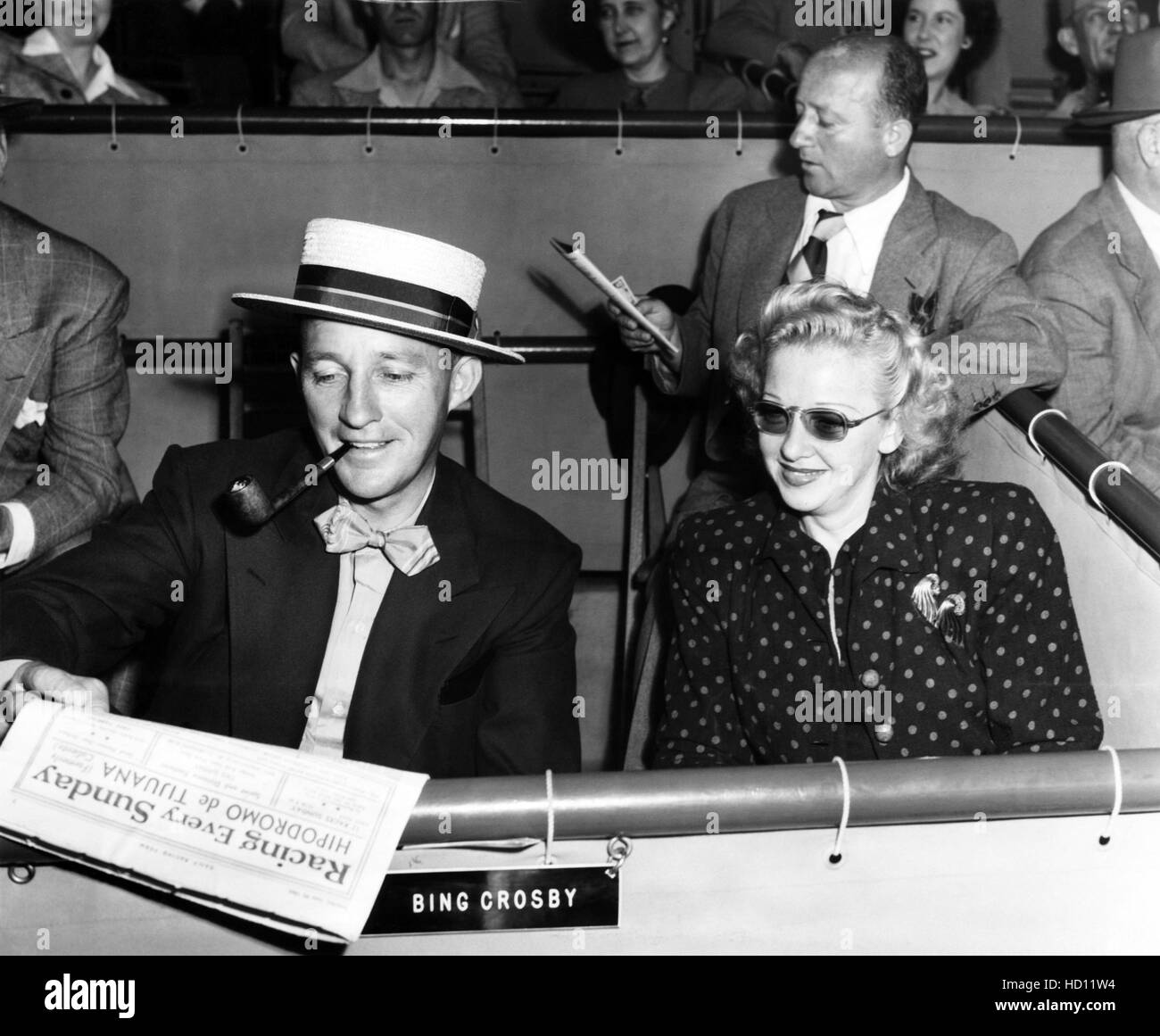 BING CROSBY and Dixie Lee check the racing form at the Santa Anita Race