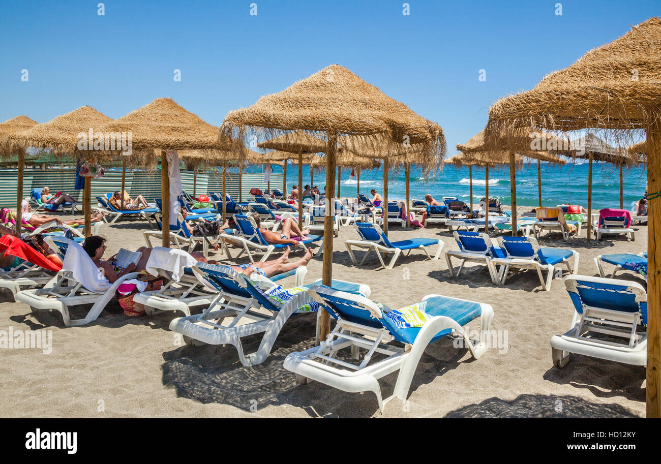 Spain, Andalusia, Province of Malaga, Costa del Sol, Marbella, beach umbrellas at Playa de Venus Stock Photo