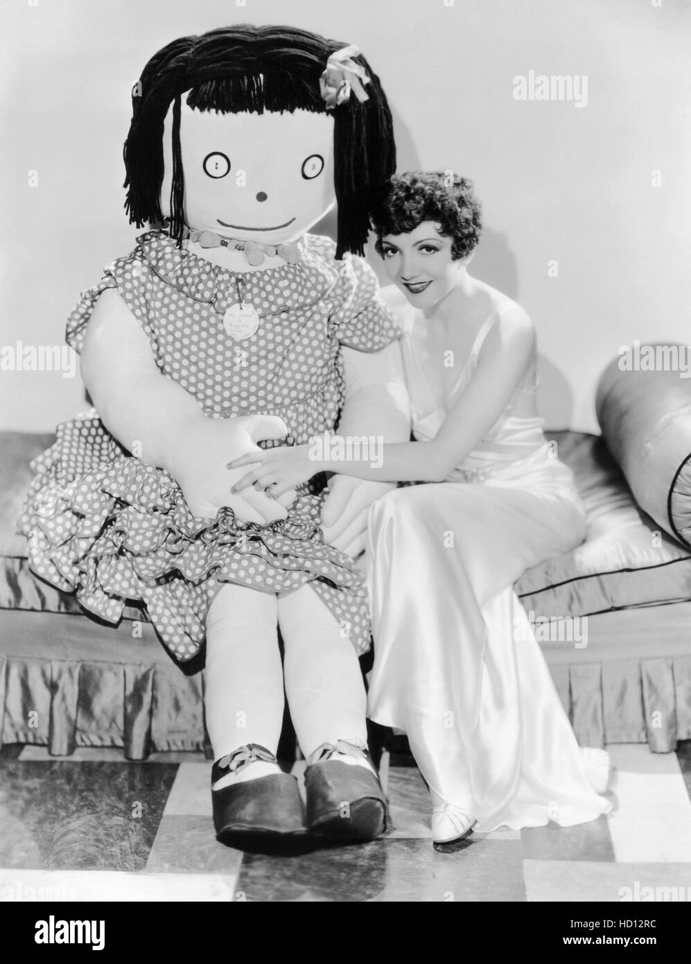Claudette Colbert with giant rag doll, early 1930s Stock Photo - Alamy