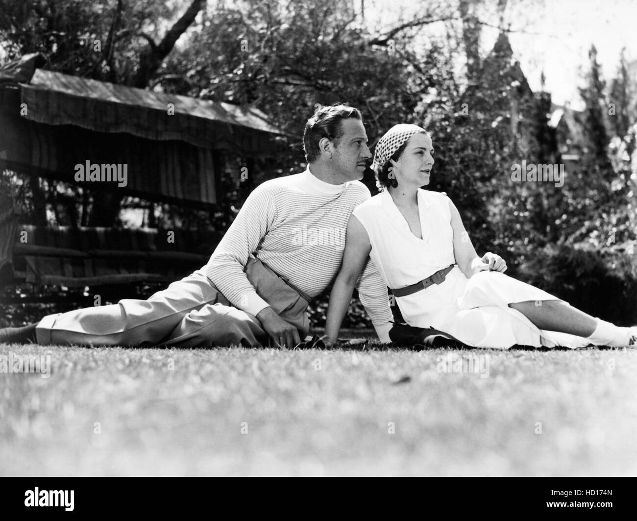 From left, Melvyn Douglas, and his wife, Helen Gahagan Douglas, in front of their Hollywood home, 1936 Stock Photo