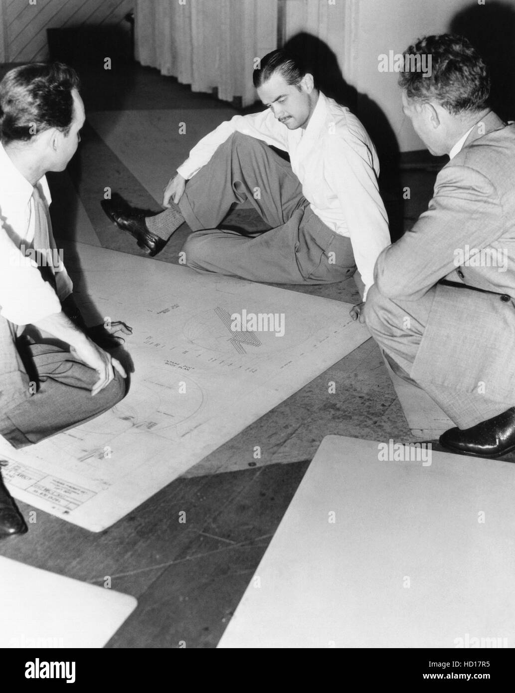 Howard Hughes, examining airplane blueprints, ca. mid-1940s Stock Photo