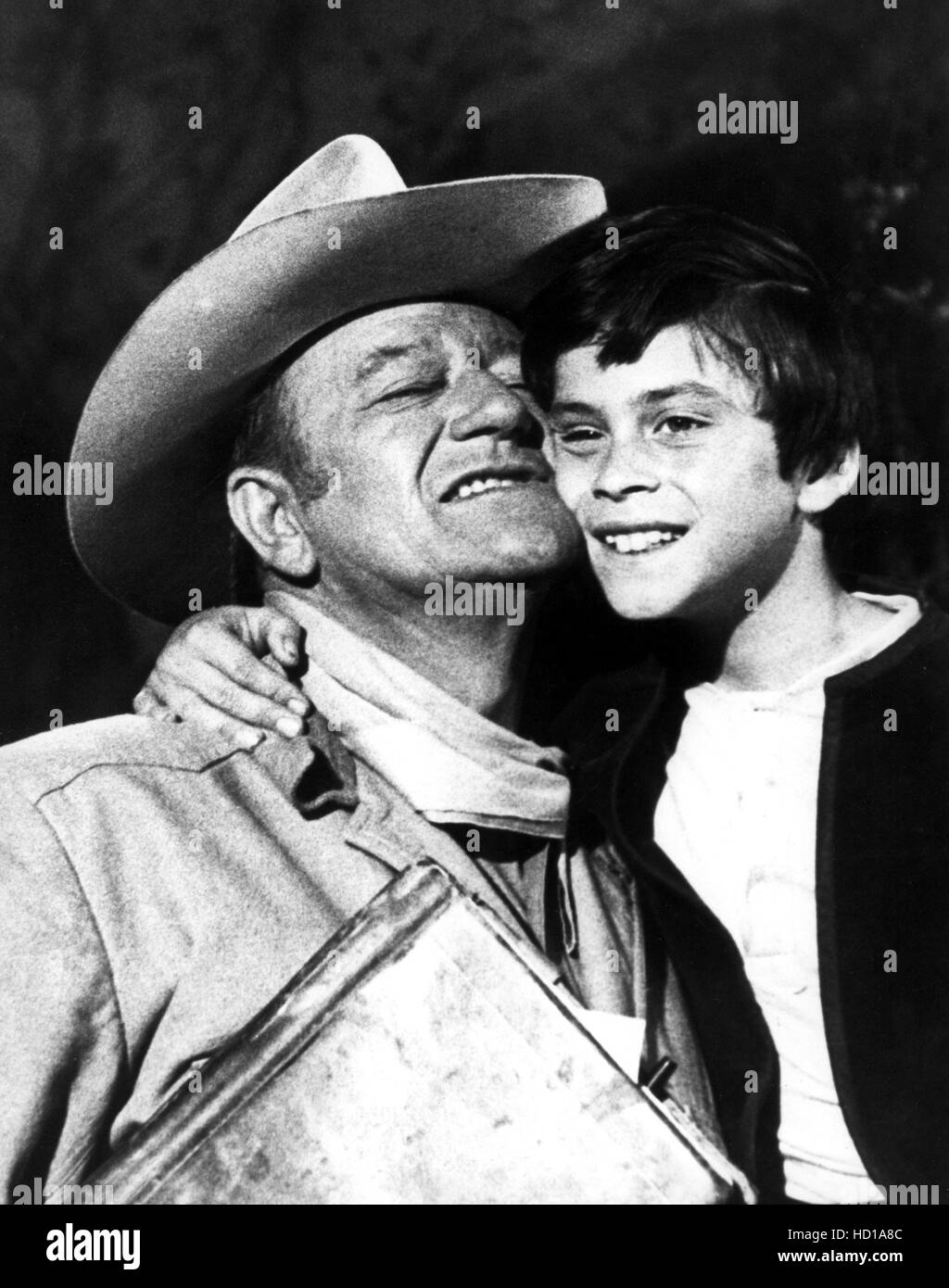 BIG JAKE, John Wayne gets a hug from son Ethan Wayne during production