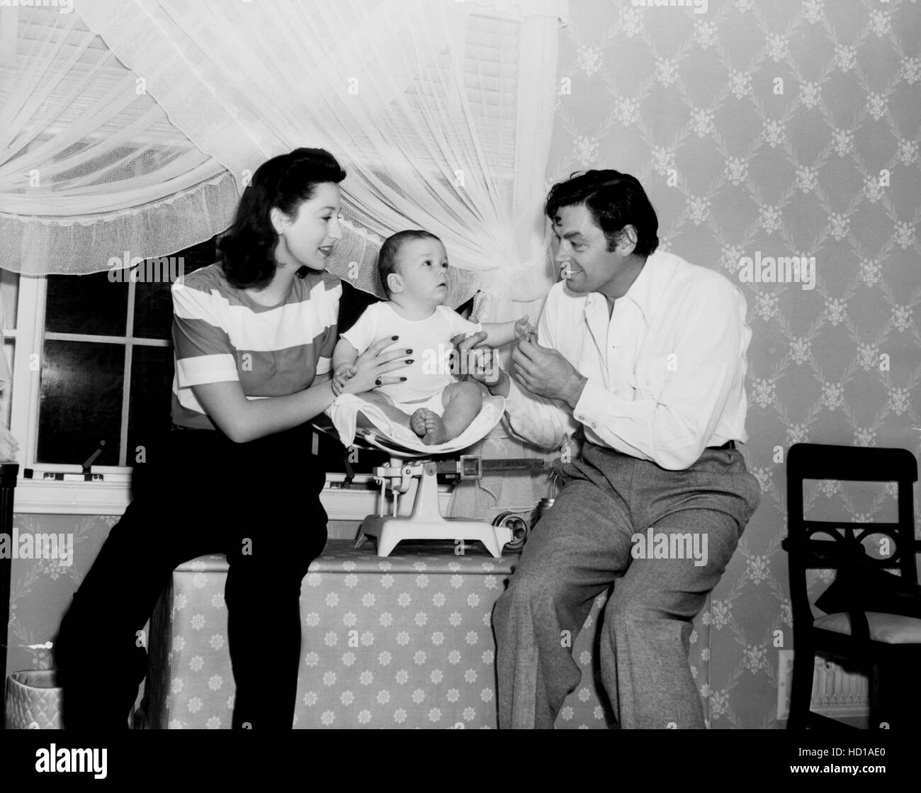 Johnny Weissmuller, right, and his fourth wife, Beryl Scott, with their six-month-old son, Johnny Weissmuller, Jr., 1941 Stock Photo