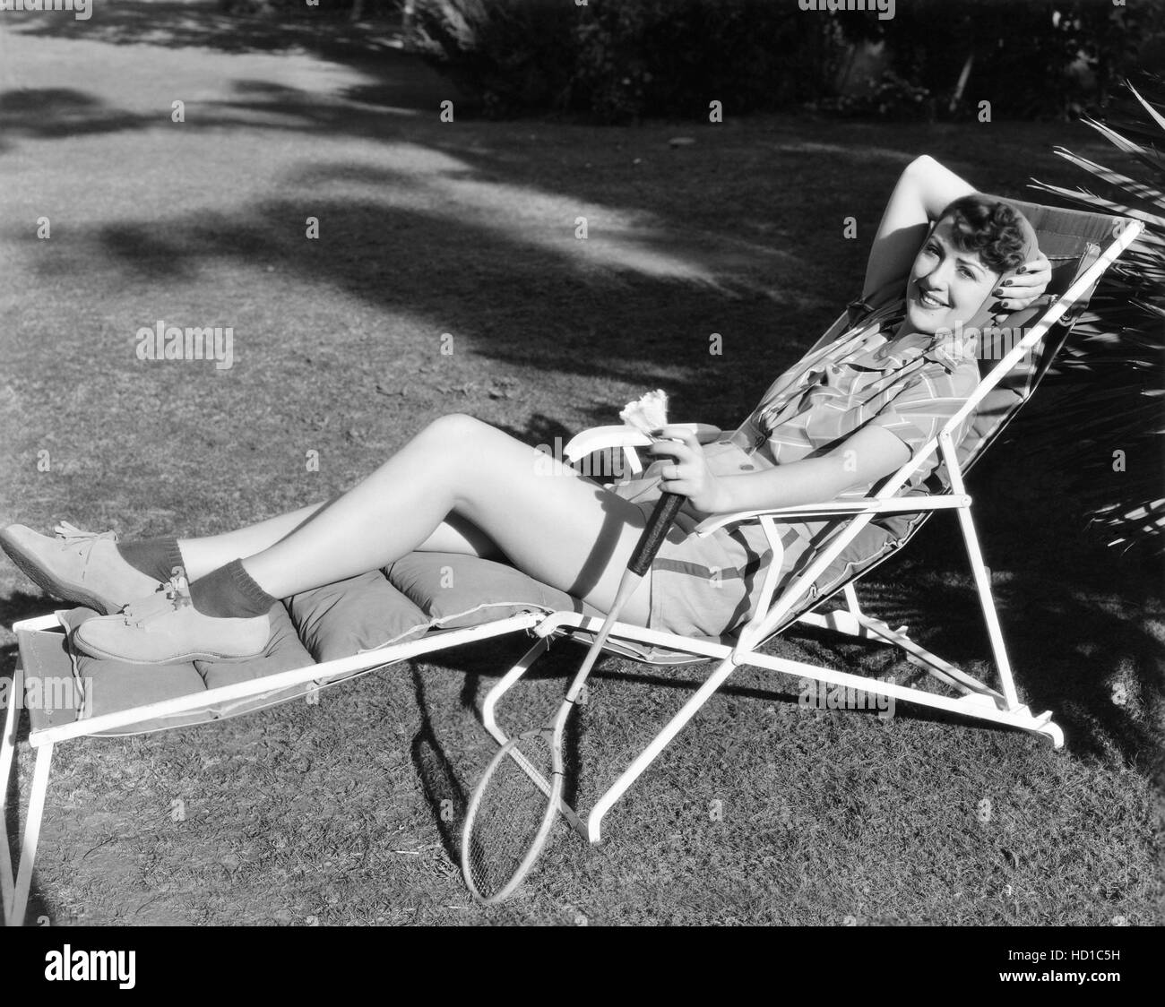 Louise Hovick (aka Gypsy Rose Lee) lounging in badminton outfit, 1938