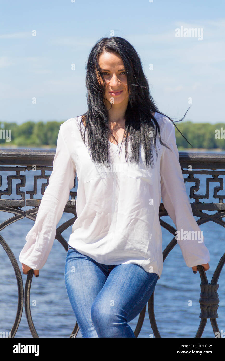 Standing young Caucasian woman on river background Stock Photo - Alamy