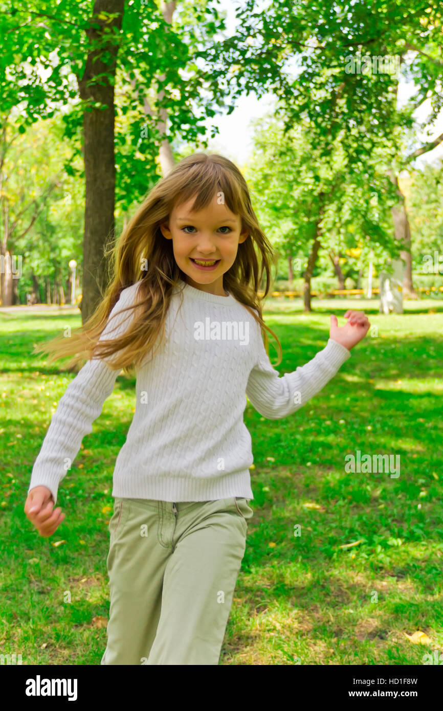Photo of cute running girl in summer Stock Photo