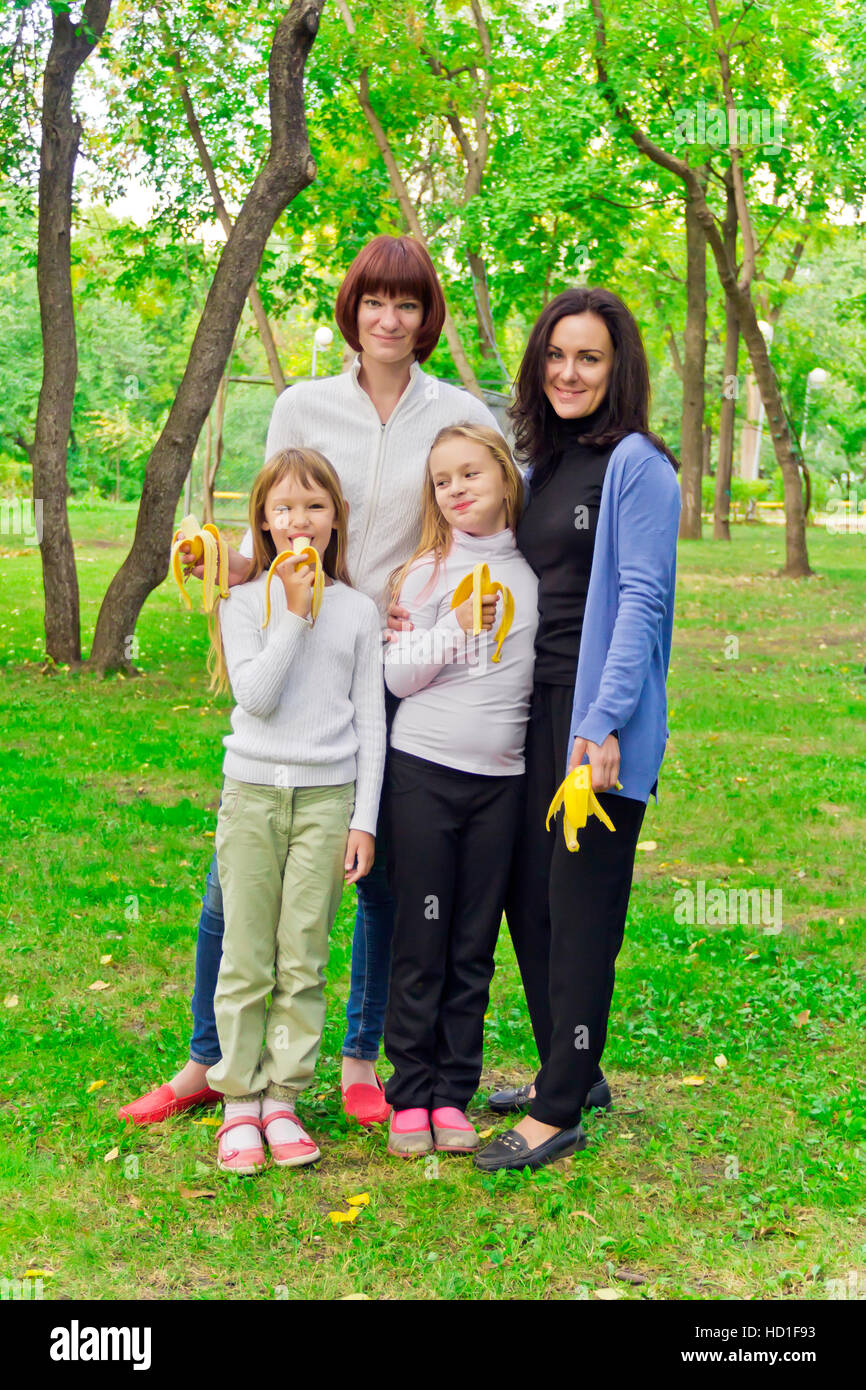 Photo of group people are eating bananas Stock Photo