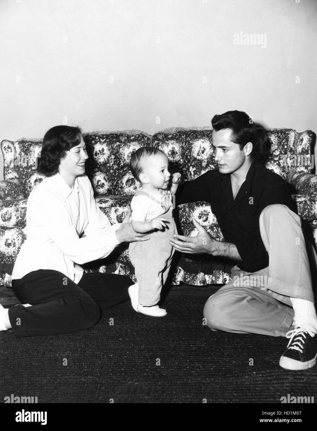 John Derek, right, at home with his first wife, actress Pati Behrs, and their son, Russell Derek, April 1951 Stock Photo
