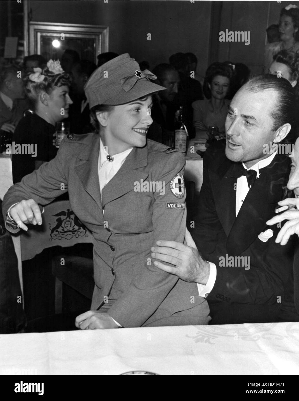 Joan Fontaine displaying her new Red Cross uniform to her husband Joan Fontaine displaying her new Red Cross uniform to her husband