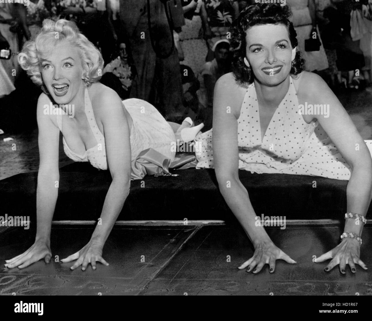 MARILYN MONROE and JANE RUSSELL place their hand prints in cement 