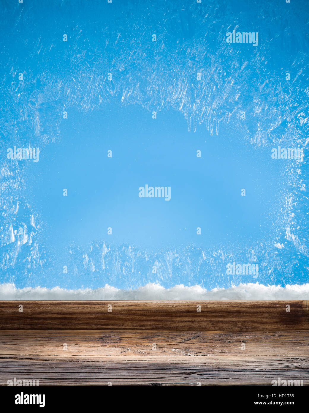 Wooden sill and frozen window. Christmas or New Year background. Stock Photo