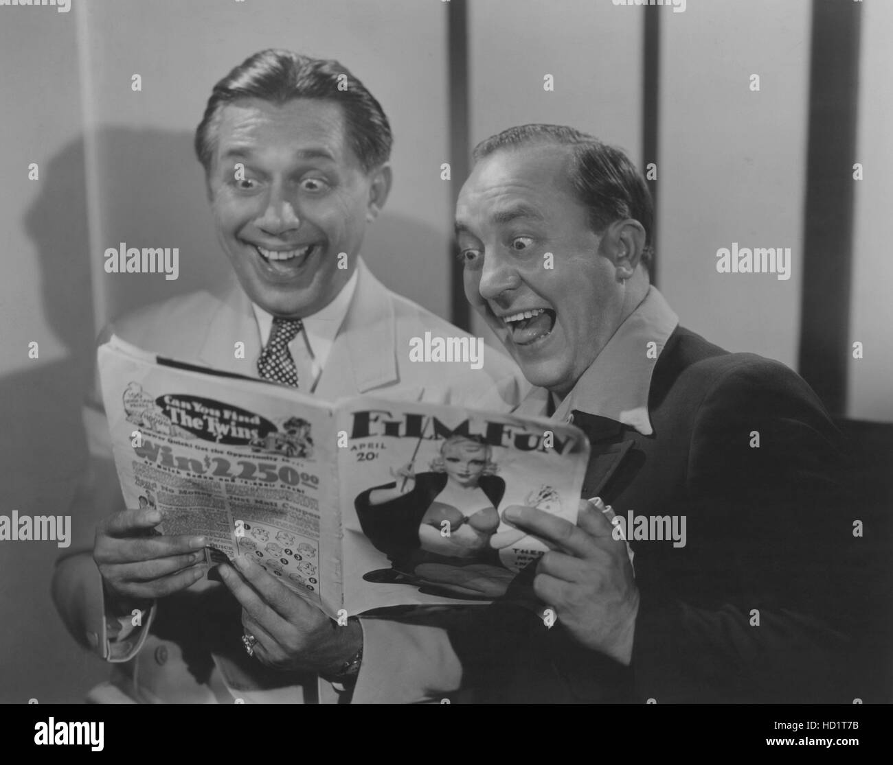 From left: Ole Olsen, Chic Johnson getting excited over a film magazine ...