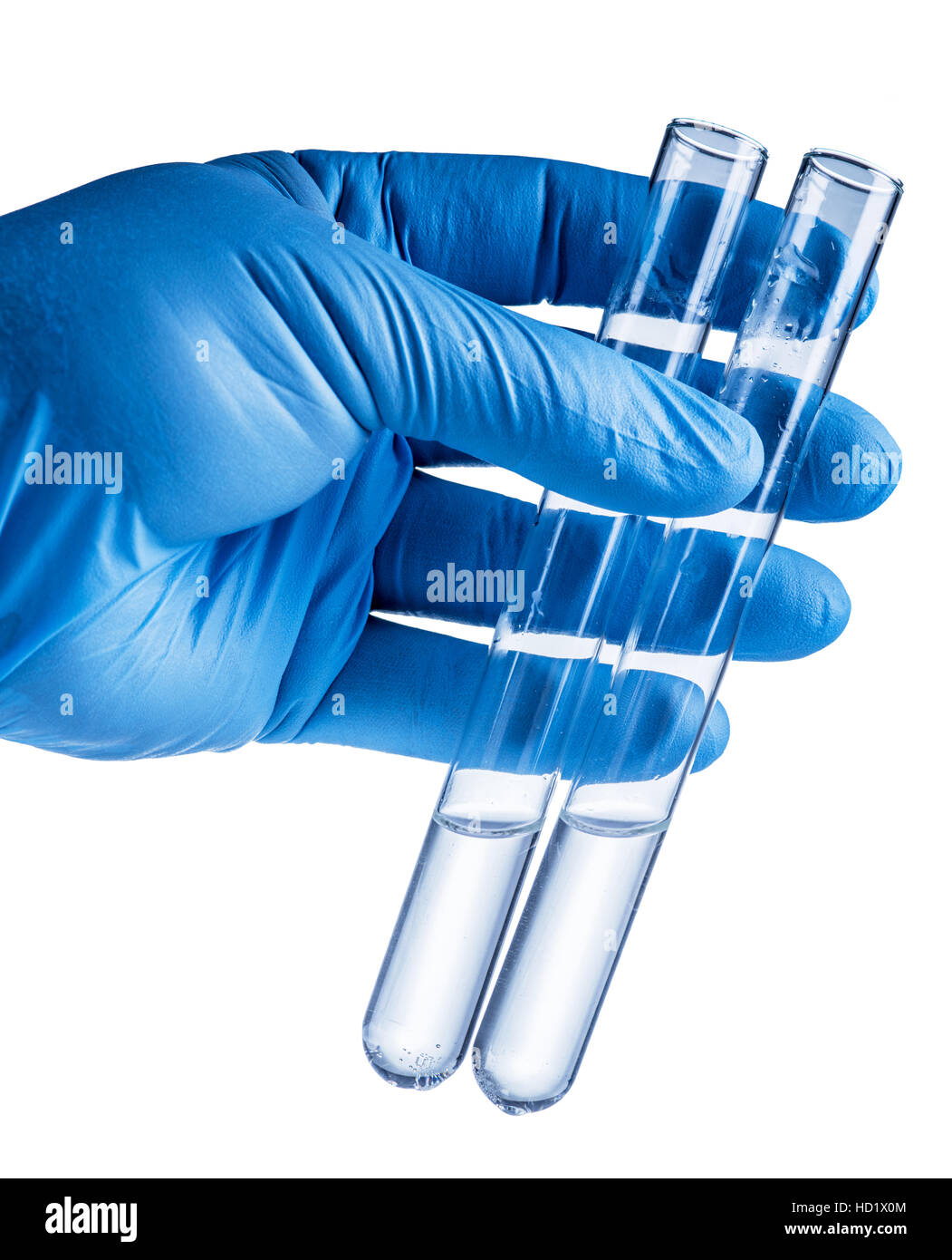 Laboratory beakers in analyst's hand in plastic glove. File contains clipping paths. Stock Photo
