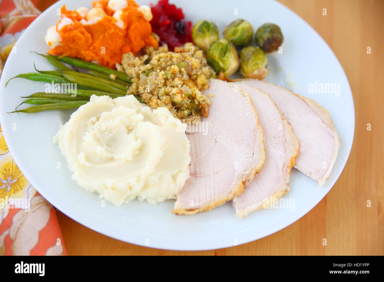 Plate of roast turkey slices, mashed potatoes, stuffing, brussels