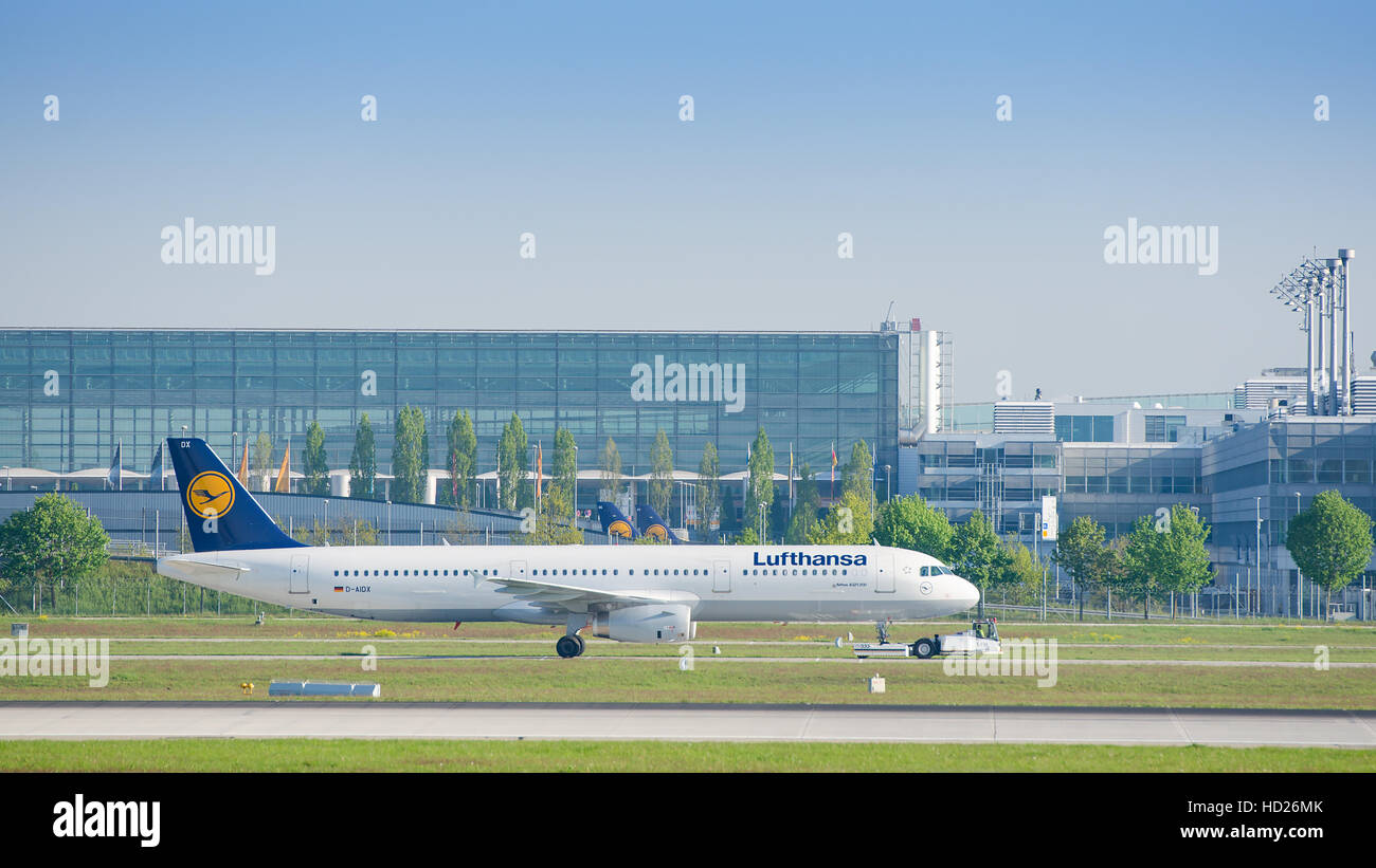 Jet airliner Airbus A321-231 of Deutsche Lufthansa AG airlines after landing taxiing on pushback tug at Munich airport Stock Photo