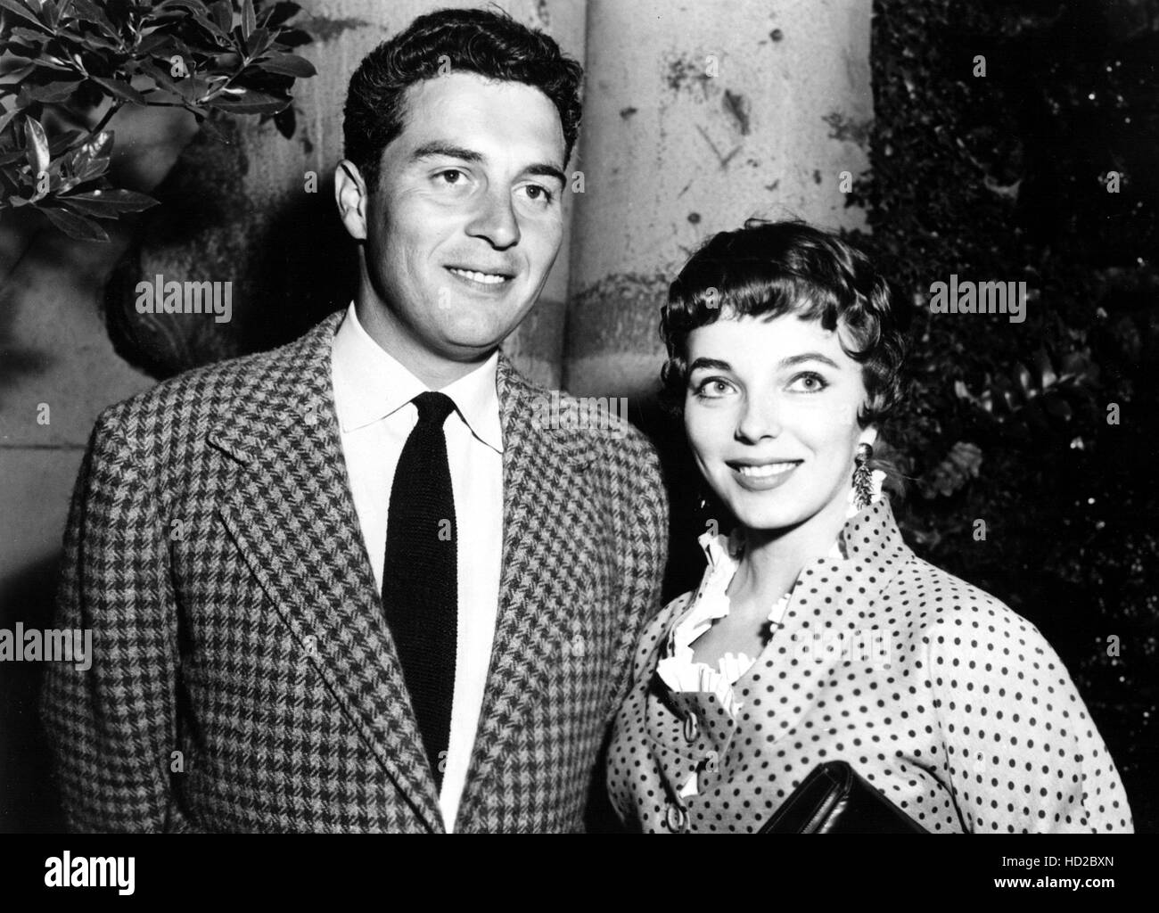 (Lr) Sydney Chaplin escorting Joan Collins to press preview of 'Land