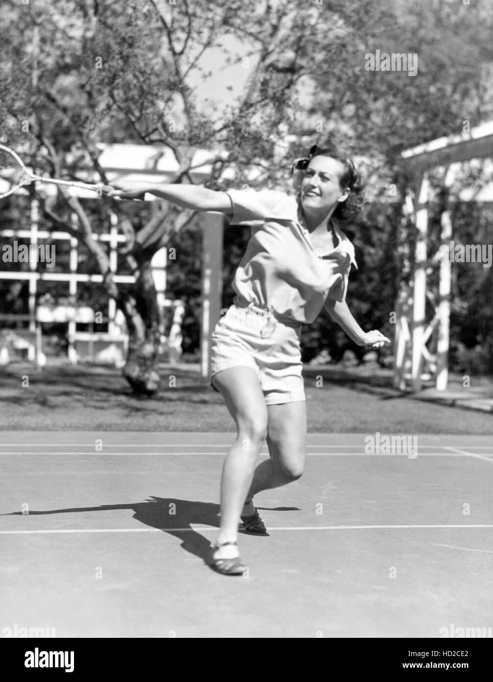 Joan Crawford, playing tennis, circa 1940s. photograph by Durward ...