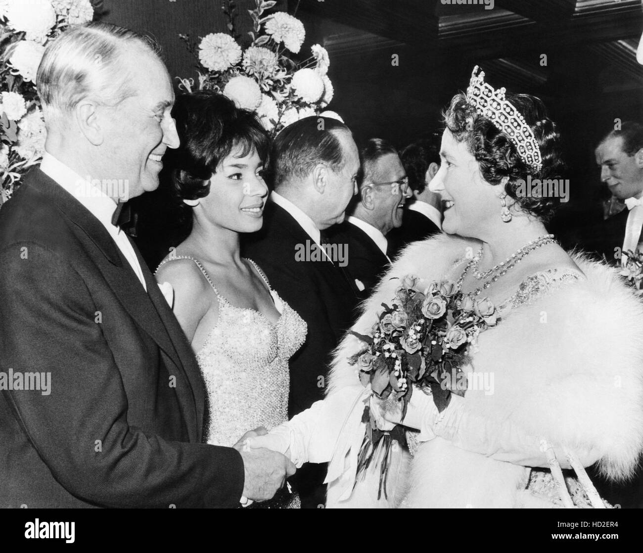 Elizabeth the Queen Mother, right, greets (from left) Maurice Chevaier ...