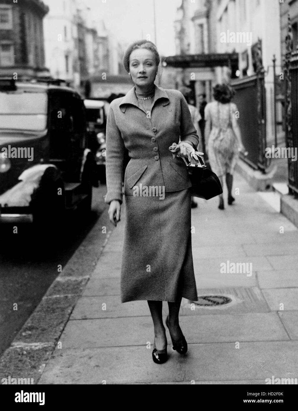 Marlene Dietrich, in a gray wool Christian Dior suit, outside the ...
