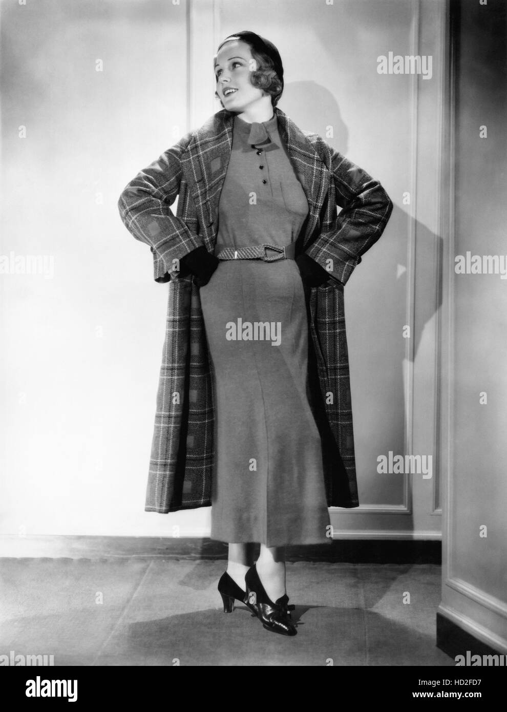 Madge Evans in an angora sports frock and plaid spring topcoat, 1934 Stock Photo