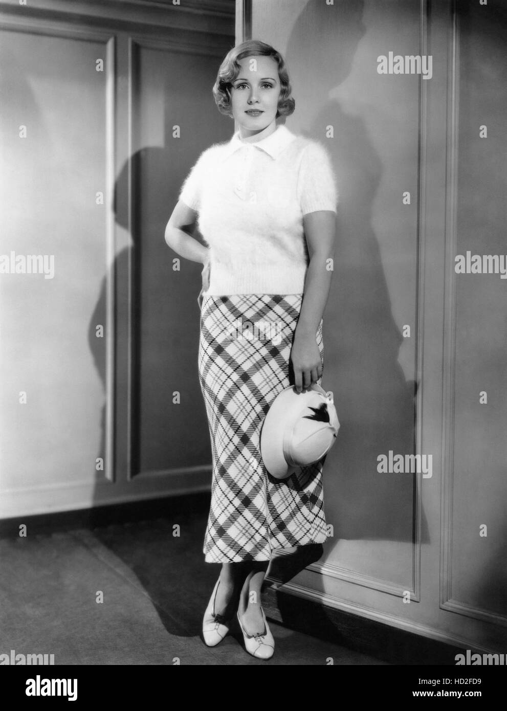Madge Evans in a plaid skirt with angora resort sweater, 1934 Stock