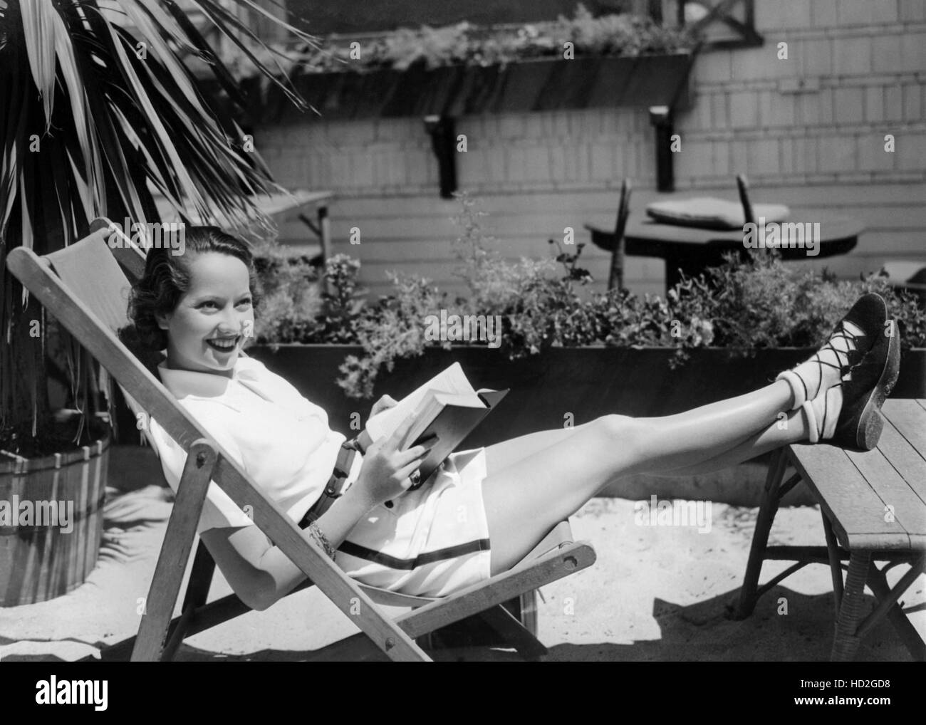 Merle Oberon relaxing in front of her beach house, ca. 1935 Stock Photo