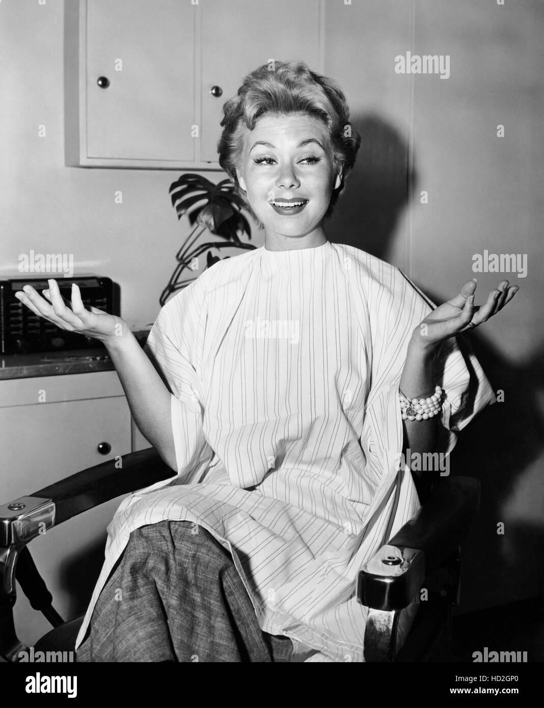 Mitzi Gaynor, in the makeup chair after having had her hair cut short ...