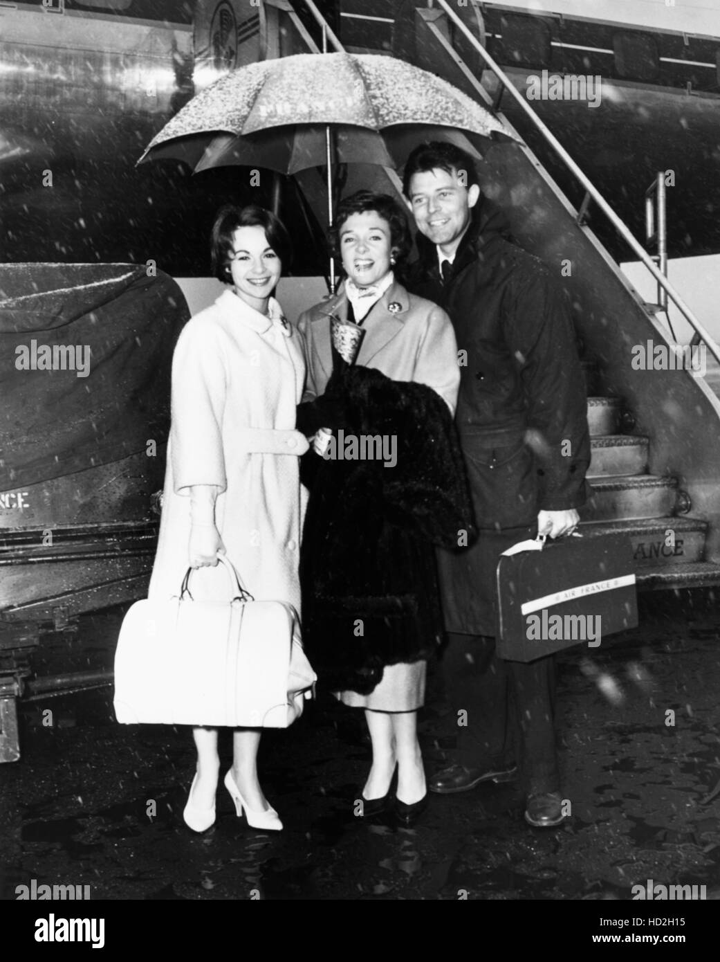 From left: French film stars Francoise Arnoul, Micheline Presle, Gerard Philipe at New York International Airport, ca. late Stock Photo