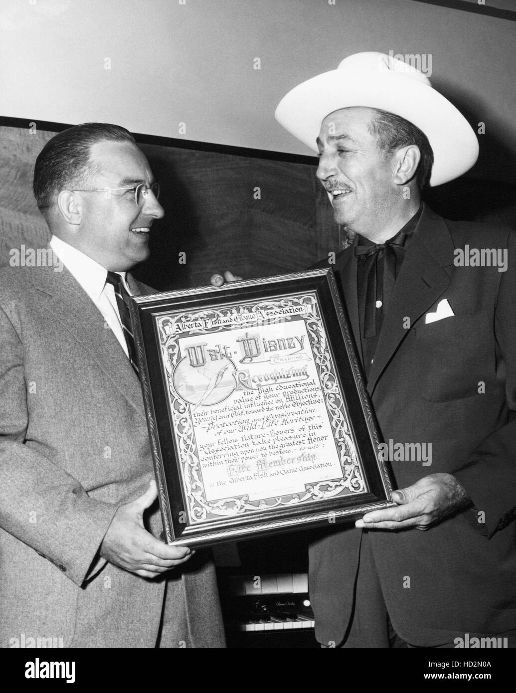 Walt Disney (right) receiving award for protecting our wildlife
