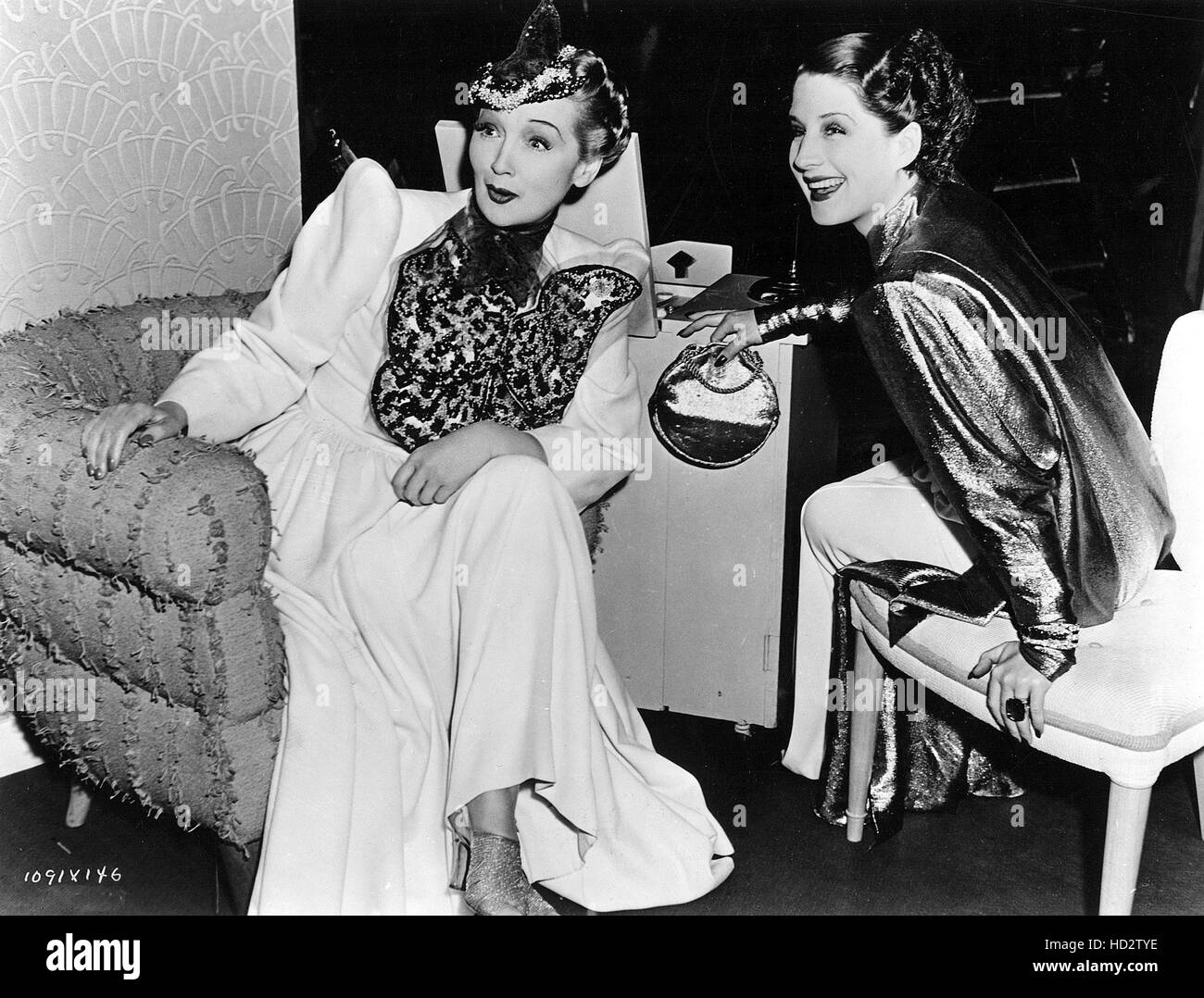 HEDDA HOPPER and NORMA SHEARER share a light moment on the set of THE