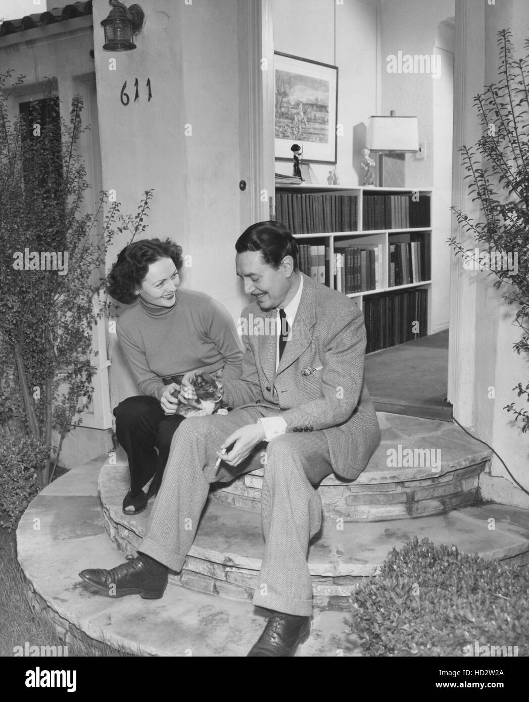 From left: Nadia Petrova, Reginald Gardiner at home with a stray cat who has adopted them, 1943 Stock Photo