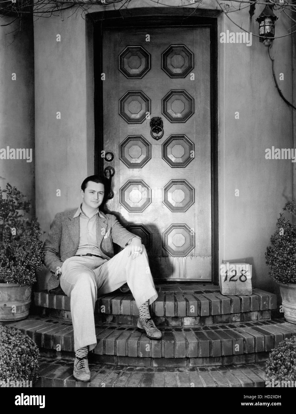 Robert Young outside the entrance to his Hollywood home, 1934 Stock