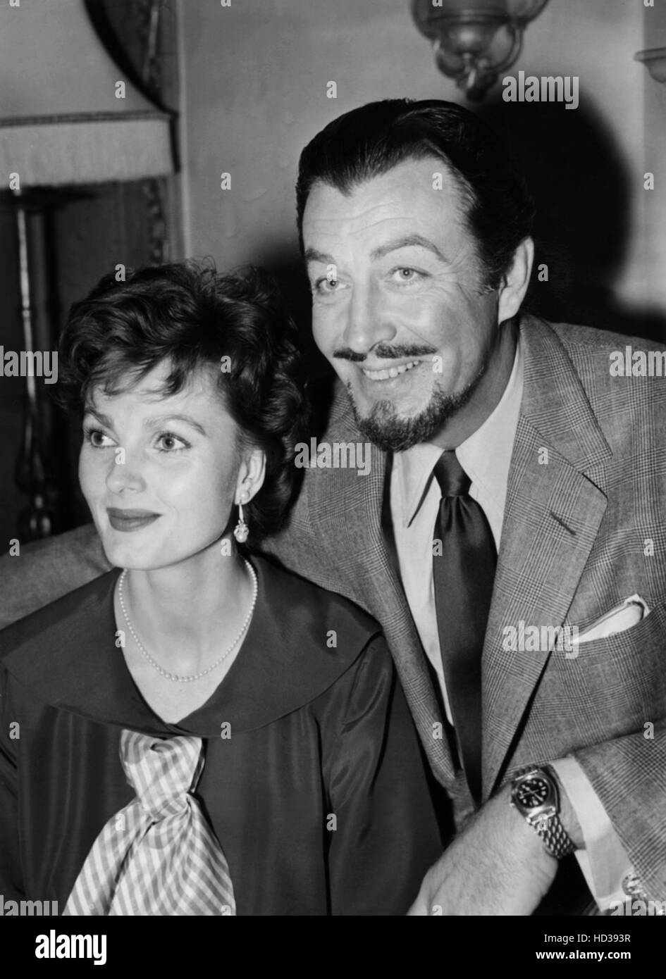 Robert Taylor, right, and his second wife, actress Ursula Thiess, at the Dorchester Hotel, London, February 1955 Stock Photo