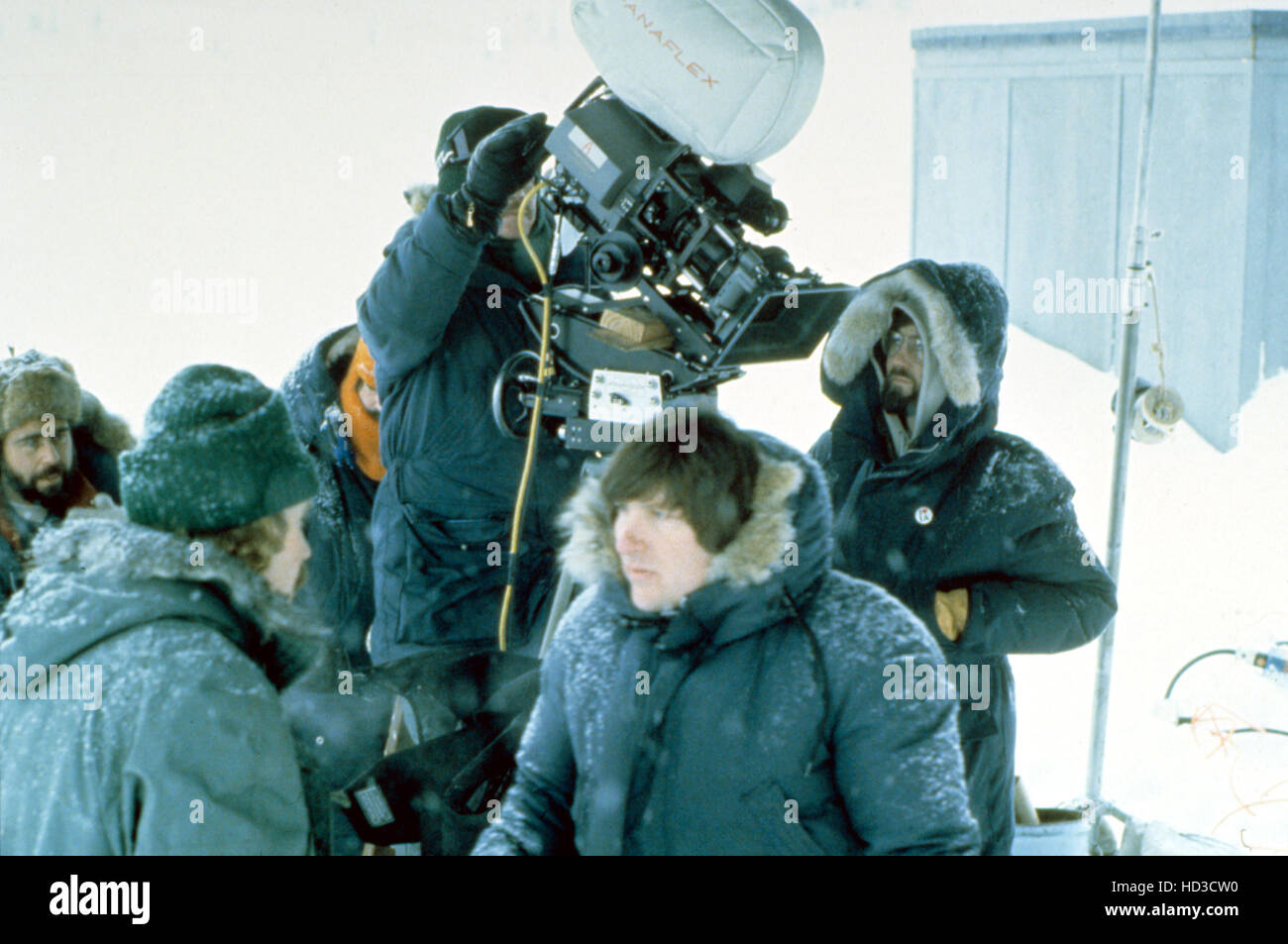 John Carpenter (back to camera, left) on the set of THE THING, 1982 Stock Photo