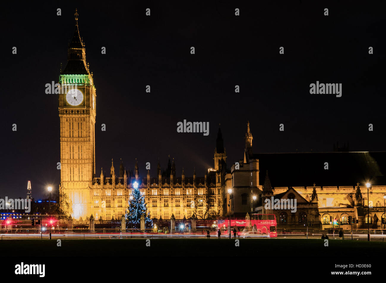 Big Ben and the Houses of Commons at Christmas at night, showing a Christmas Tree and a London bus. Stock Photo